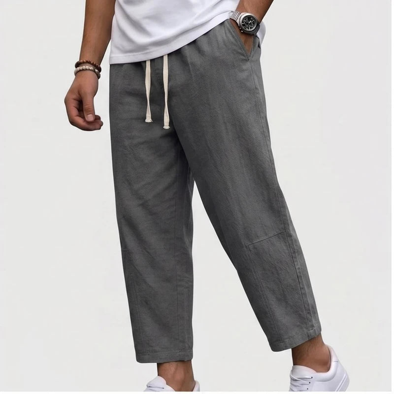 Model wearing Gray Raymond - Men’s Drawstring Relaxed Linen Pants in studio