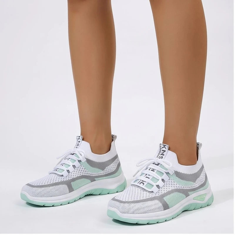 Model wearing Green Kesslyn Mesh Running Sneakers in studio