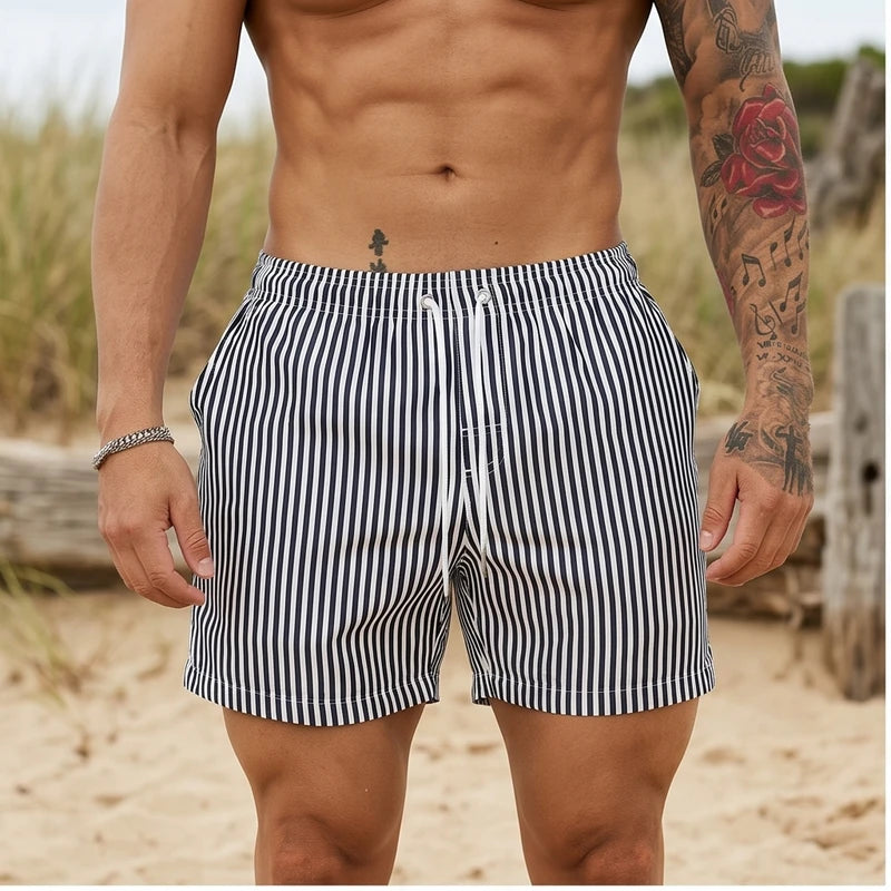 Model wearing Black Huxley Striped Swim Trunks outdoors