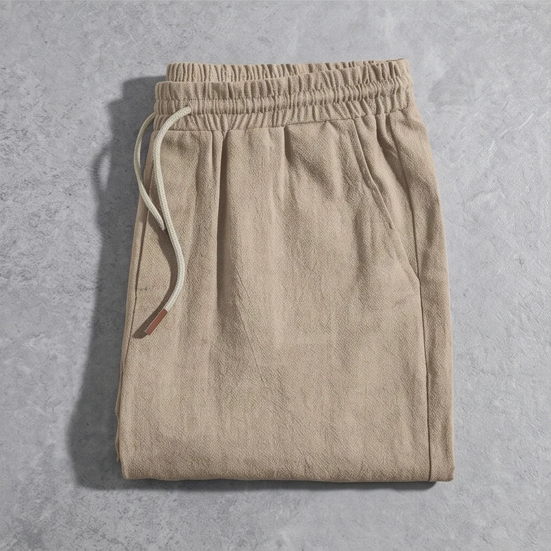 Tan linen drawstring shorts with a relaxed fit.