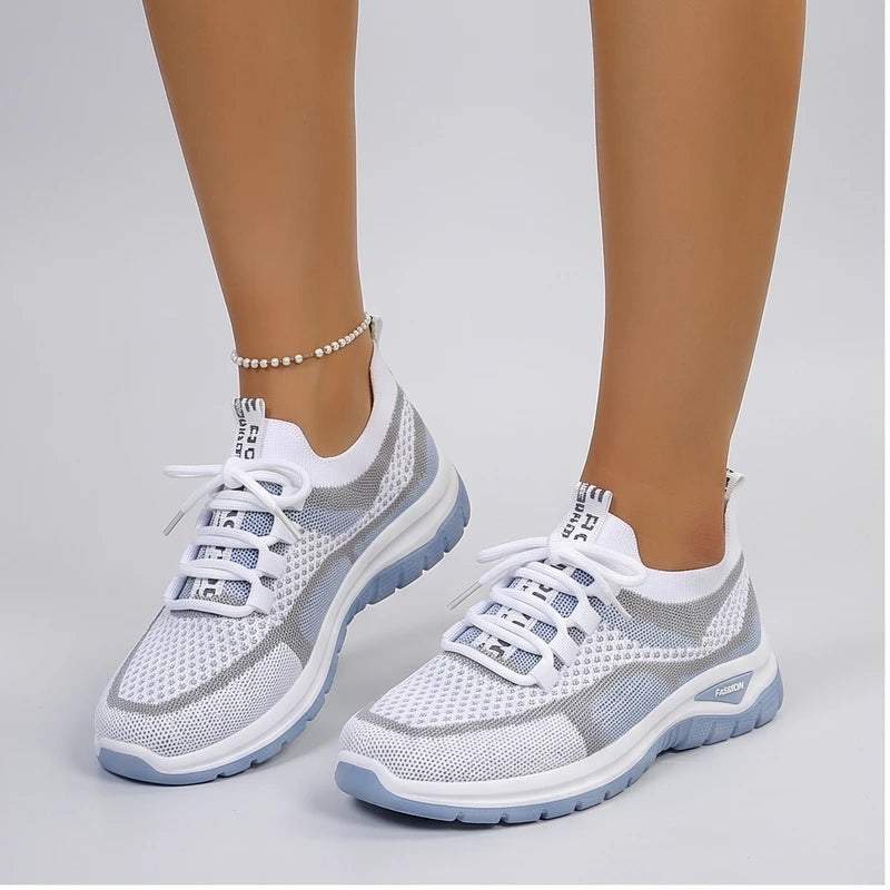 Model wearing Blue Kesslyn Mesh Running Sneakers in studio