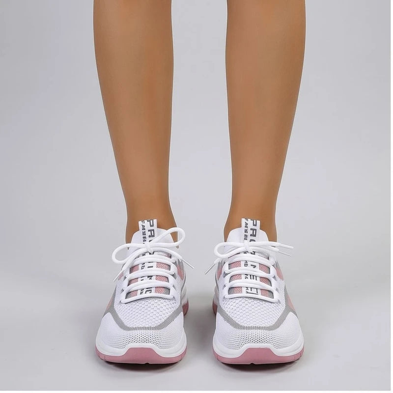 Model wearing Pink Kesslyn Mesh Running Sneakers in studio