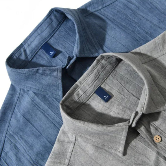 Two shirts, one blue and one gray, with a brand logo on a light gray background.