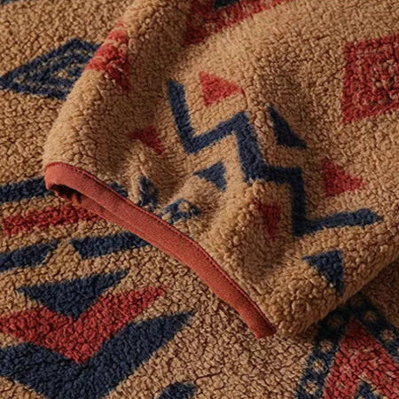 Close-up of a textured fabric with geometric patterns in red, blue, and beige.