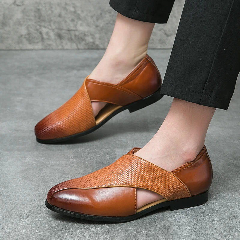 Brown leather shoes worn by a person on a gray concrete floor