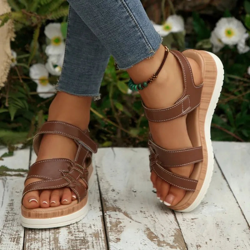 Brown leather Valencia platform wedge sandals with crisscross straps.