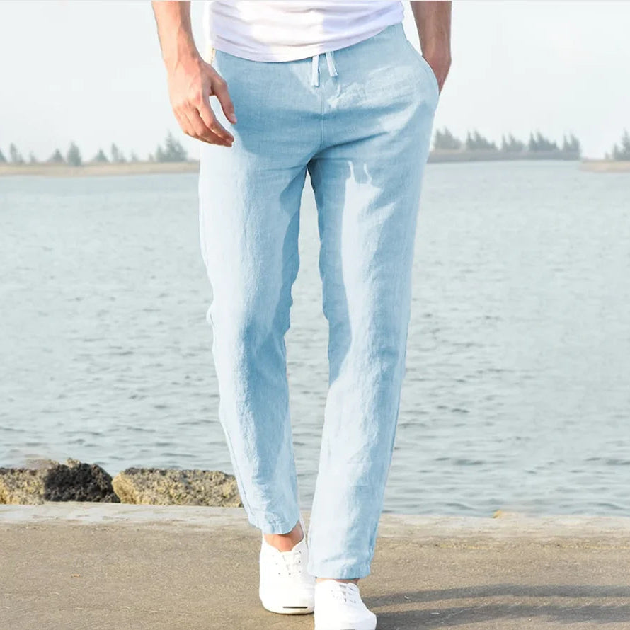 Light blue linen trousers for men, featuring a relaxed fit and drawstring waist.