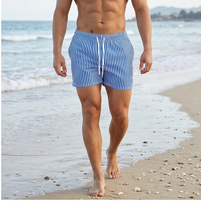 Model wearing Blue Huxley Striped Swim Trunks outdoors