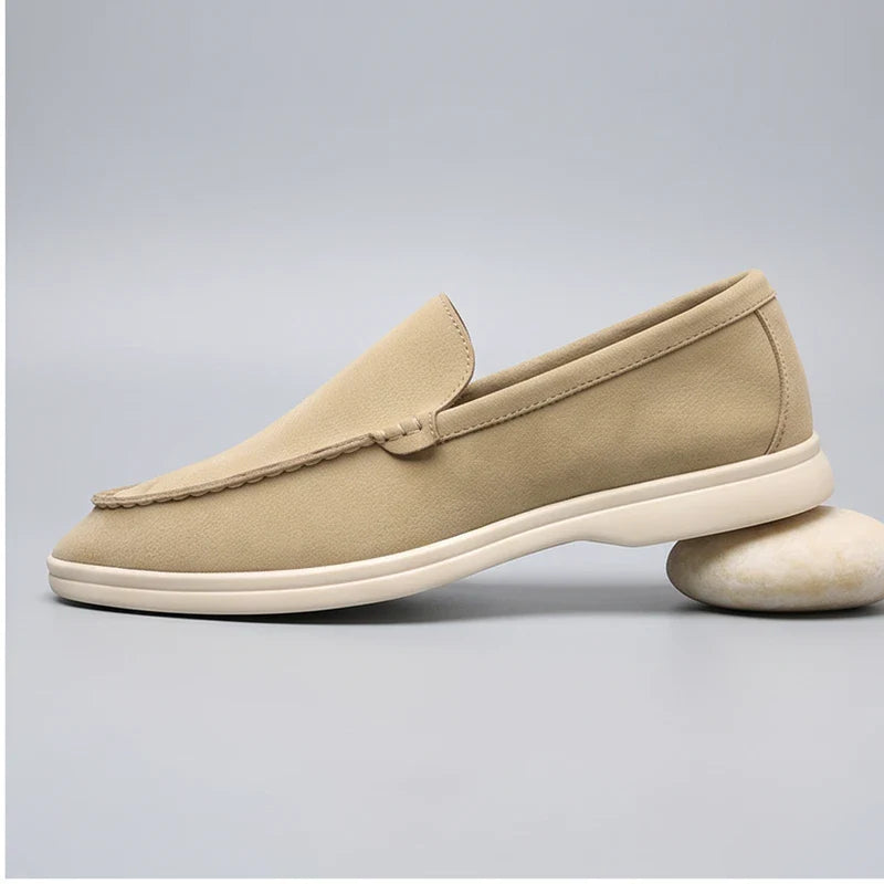 Beige suede loafers in a studio background - 2