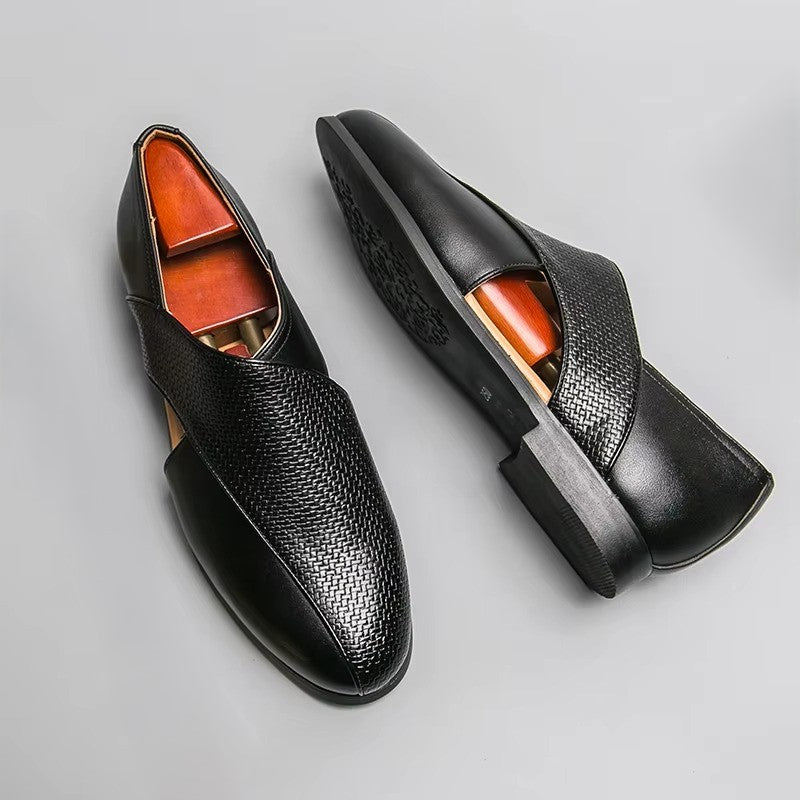 Pair of black leather shoes on a gray background