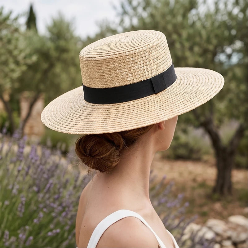 Straw boater hat in natural with black ribbon.