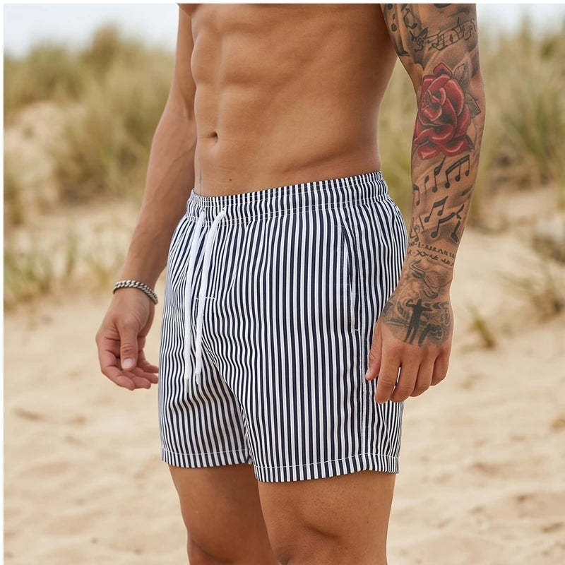 Model wearing Black Huxley Striped Swim Trunks outdoors - 2