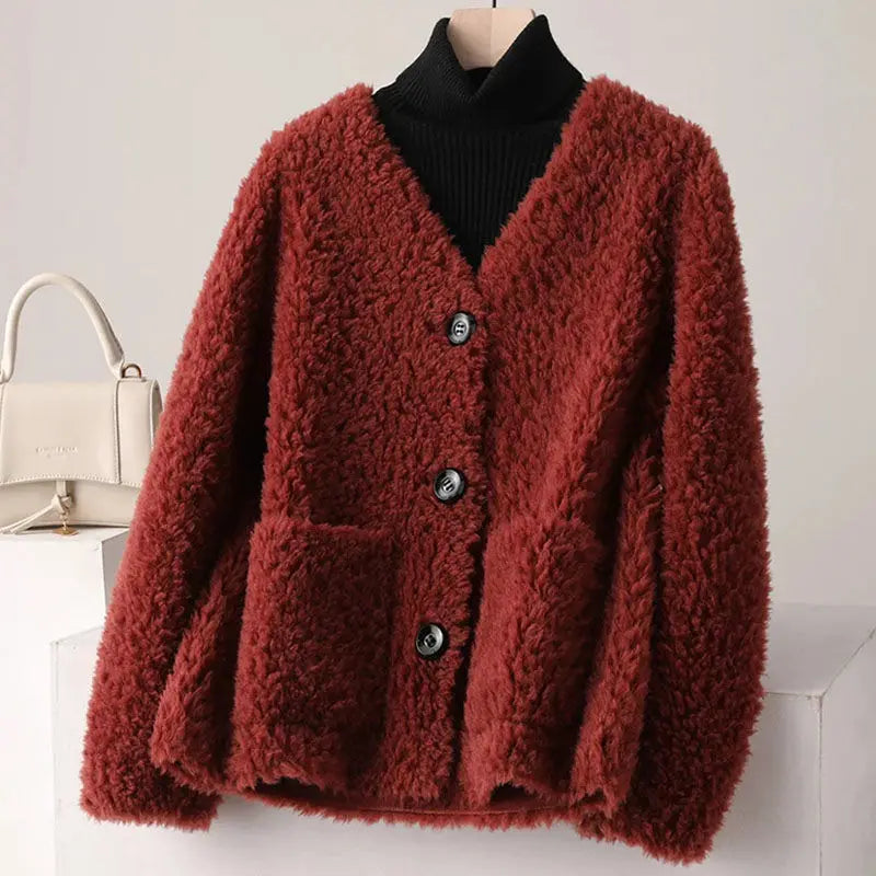 Red fluffy cardigan on a mannequin with a white background