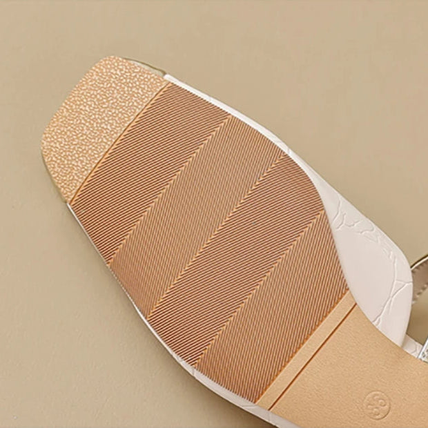 Close-up of a shoe sole with text on a beige background