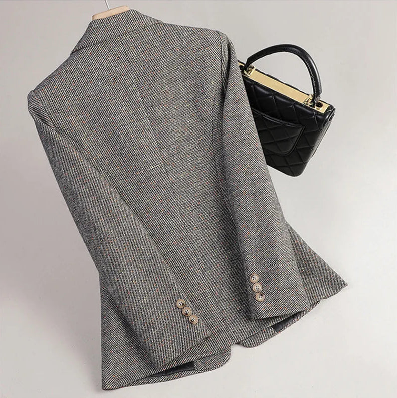 Gray textured fabric with a black handbag on a light gray background