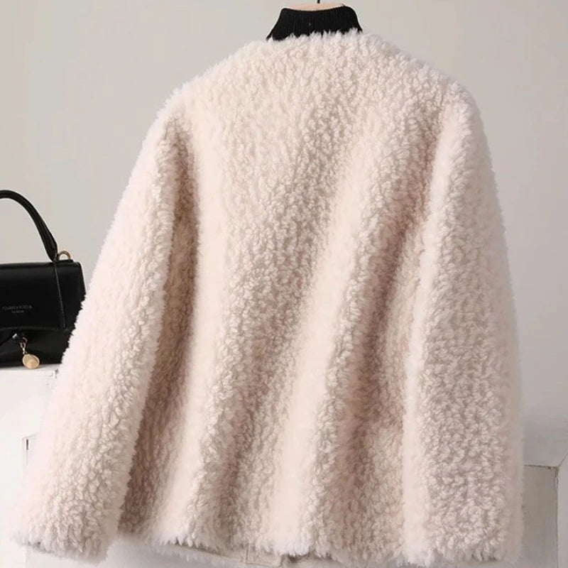 White fluffy coat on a mannequin with a black handbag in the background