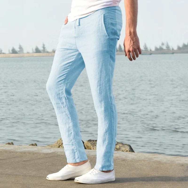 Men's sky blue linen trousers, casual drawstring style.