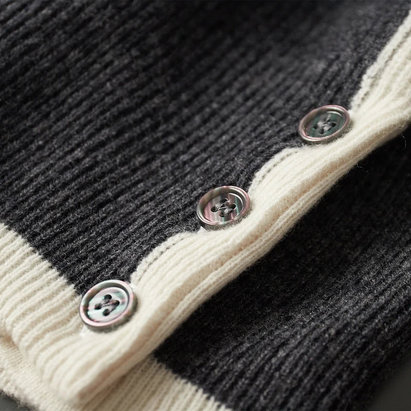 Close-up of a black and white cardigan with buttons on a dark background
