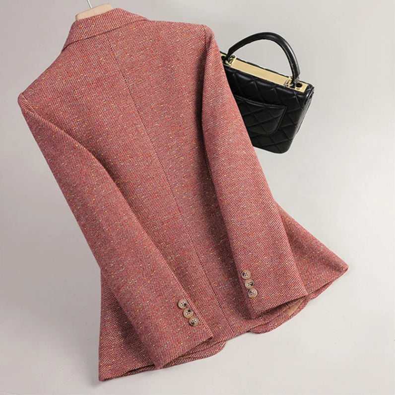 Red textured coat with buttons and a black handbag on a light gray background