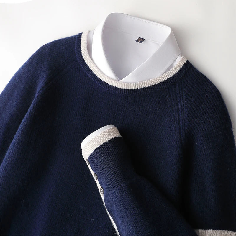 Navy blue sweater with white collar and cuffs on a light gray background