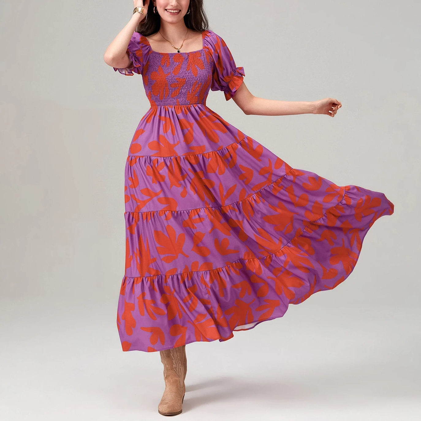 Woman wearing a purple and red patterned dress on a gray background