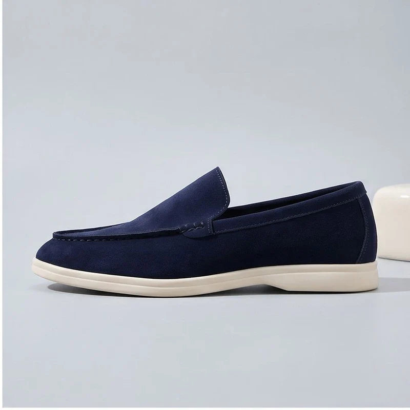 dark blue suede loafers in a studio background - 2