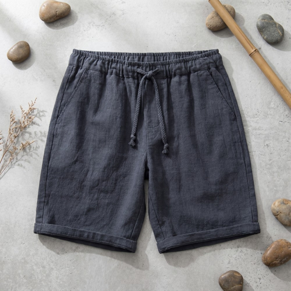 Charcoal linen drawstring shorts with wide cuffs.